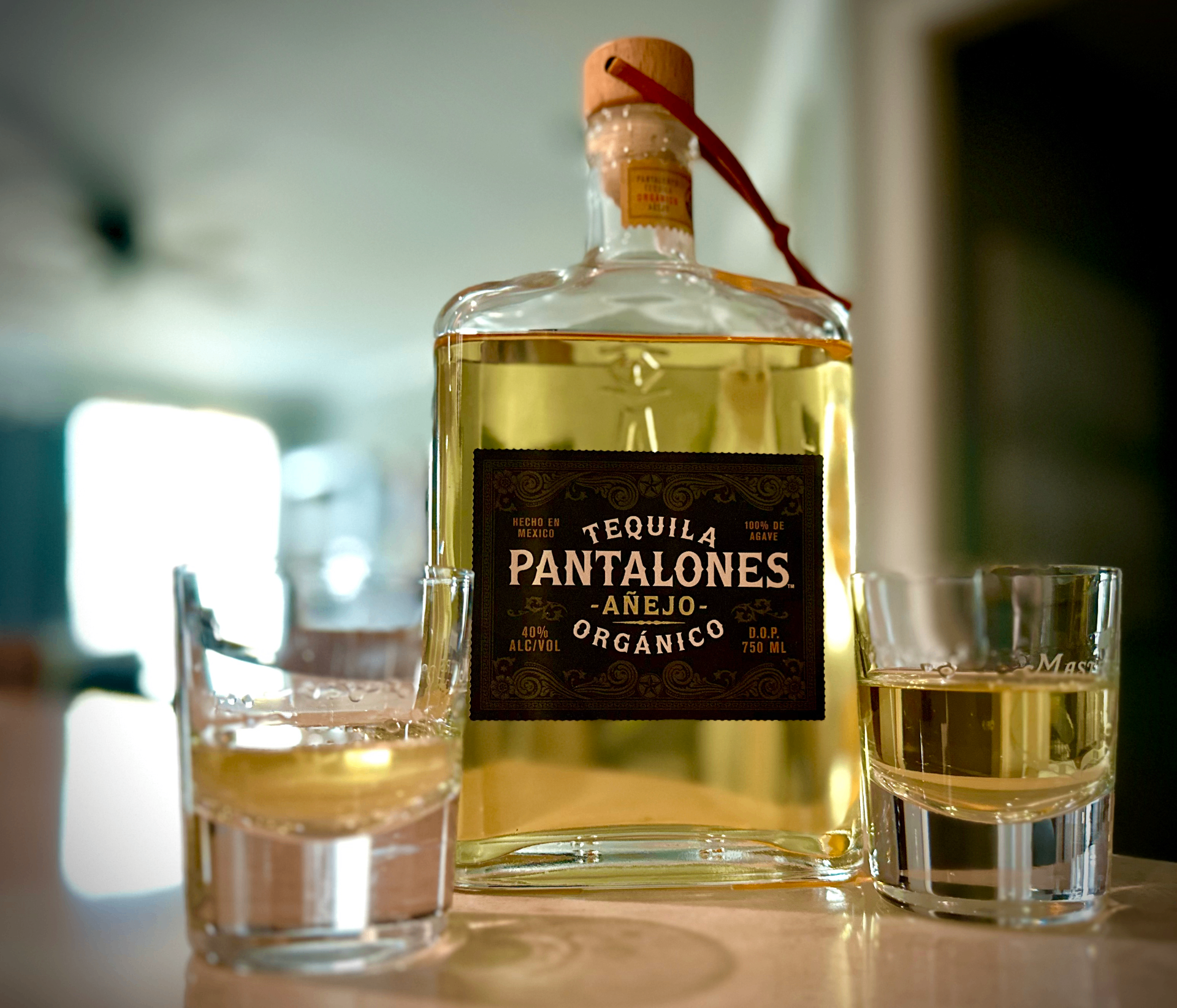 Pantalones Tequila Extra Anejo bottle with a crafted cocktail